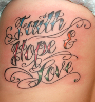 Scripty tattoo with the words Faith, Hope, and Love